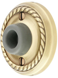 Wall-Mount Door Stop with Rope Rosette and Rubber Bumper in Antique Brass.